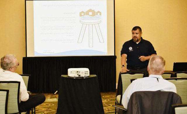 A representative of FEMA stands in front of a presentation in a meeting room at the 2019 Texas REALTORS® Conference in Fort Worth.
